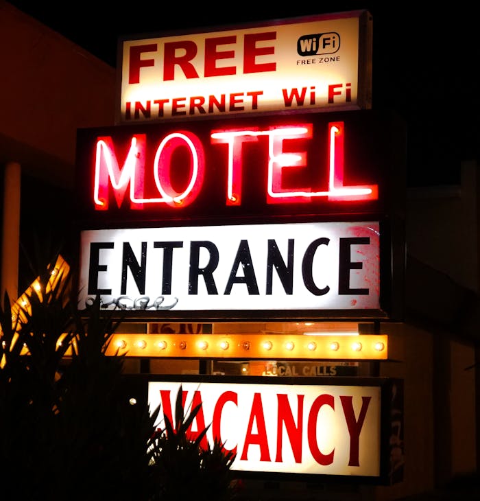 journey-01 Illuminated neon motel sign advertising free Wi-Fi and vacancy at night.